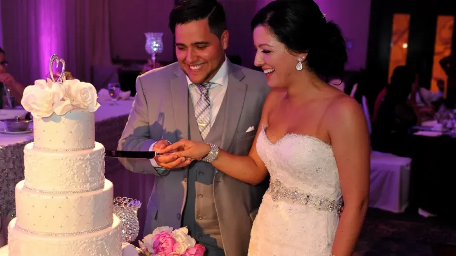 jennifer and pedro wedding photo with their wedding cake
